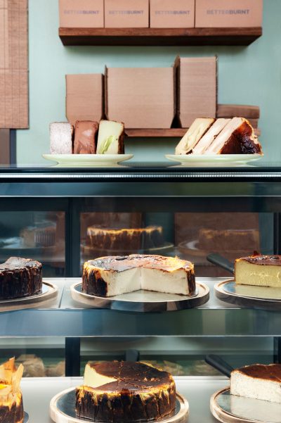 Close-up of burnt Basque cheesecakes in the display cabinet at Better Burnt café.