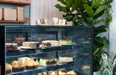 Burnt Basque cheesecakes displayed inside Better Burnt café’s custom timber and glass counter.