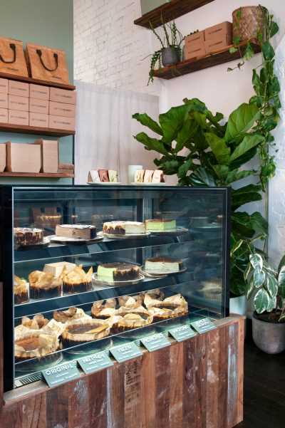 Burnt Basque cheesecakes displayed inside Better Burnt café’s custom timber and glass counter.