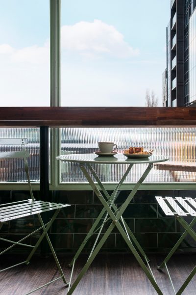 utdoor café seating at Better Burnt, styled by The Stylesmiths with sage green chairs and timber tables in London.