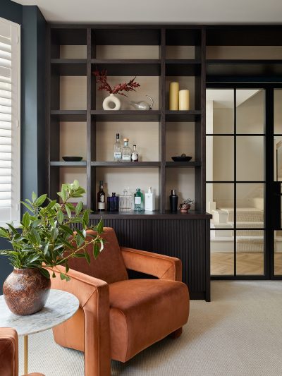 London living space with bespoke joinery, warm textures, and contemporary seating by The Stylesmiths interior designers.