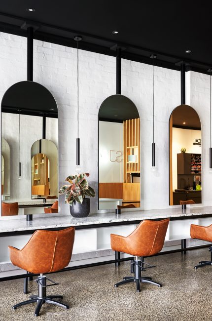 Finchley commercial interior with arched mirrors, leather chairs, and minimalist styling designed by The Stylesmiths London.