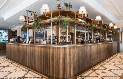 Finchley bar interior with timber paneling, brass finishes, and tiled flooring designed by The Stylesmiths London.