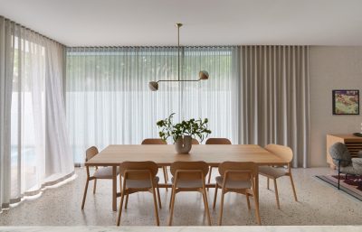 Kentish Town dining room interior with natural timber furniture, soft drapery, and minimalist decor by The Stylesmiths London.