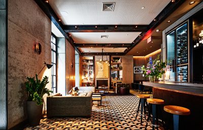 King’s Cross bar interior with geometric tiled flooring, leather seating, and ambient lighting designed by The Stylesmiths London.