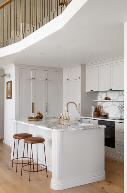 Lambeth kitchen with marble island, brass fixtures, and white shaker cabinetry designed by The Stylesmiths London.