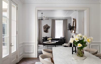 Lambeth dining room with marble table, soft grey chairs, and classic wall panelling designed by The Stylesmiths London.