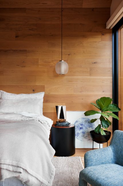 Limehouse bedroom interior with timber panelling, neutral linen bedding, and natural light designed by The Stylesmiths London.
