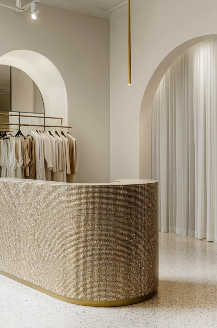 Elegant Limehouse retail boutique with arched openings, brass details, and minimal aesthetic by The Stylesmiths London.