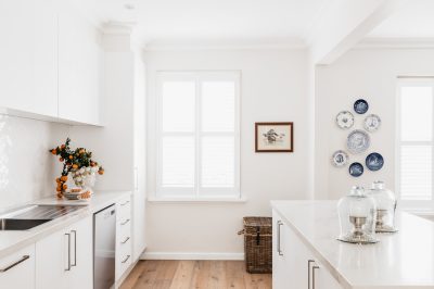 White London kitchen with blue and white decorative plate wall and timber floors.