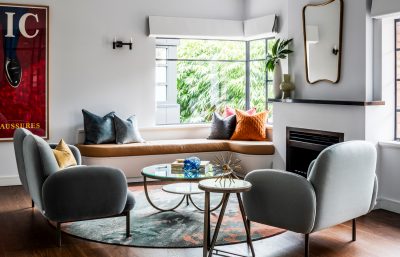 Industrial-style Tottenham loft living room with exposed beams, mid-century furniture, and textured finishes.