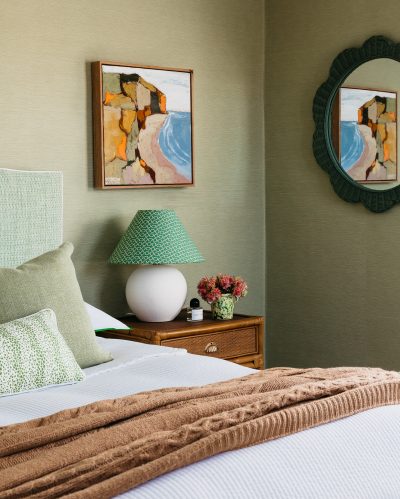London bedroom with green upholstered bedhead and botanical tones by The Stylesmiths London.