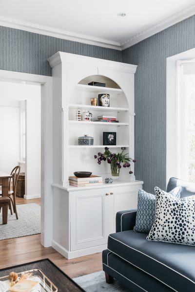 Blue and white London living room with bespoke cabinetry and patterned furnishings designed by The Stylesmiths London.