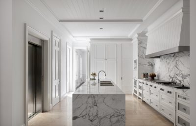 Paddington kitchen interior with marble island, white cabinetry, and brass fixtures designed by The Stylesmiths London.