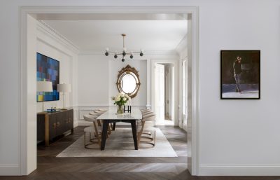 Sophisticated Pimlico dining room with marble table, gold-framed mirror, and herringbone flooring.