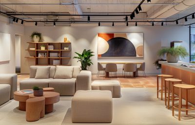 Wembley showroom interior with terracotta tones, modular furniture, and modern art designed by The Stylesmiths London.