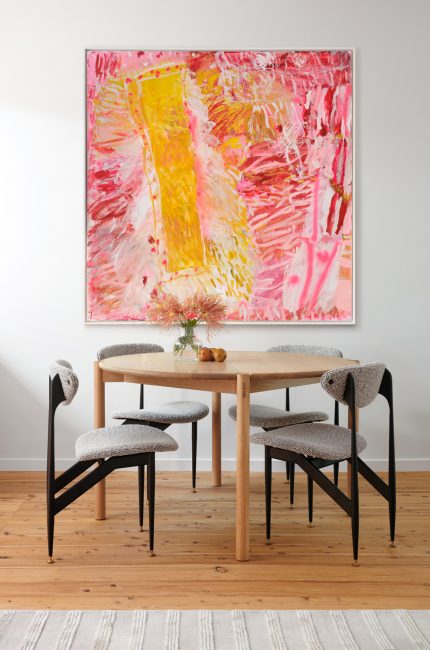 Wembley dining room interior with timber table, sculptural chairs, and vibrant modern artwork designed by The Stylesmiths London.