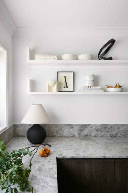 Wimbledon interior styling with stone countertop, black lamp, and sculptural home decor designed by The Stylesmiths London.