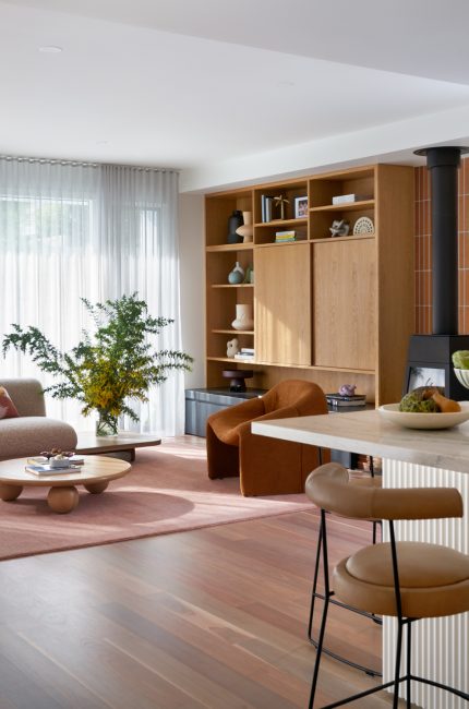 Open-plan London apartment with wood panelling, soft furnishings, and defined living zones designed by The Stylesmiths London.