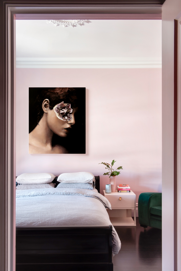 London bedroom sustainable interior with soft pink tonal walls, contemporary art statement and calm modern styling by The Stylesmiths.