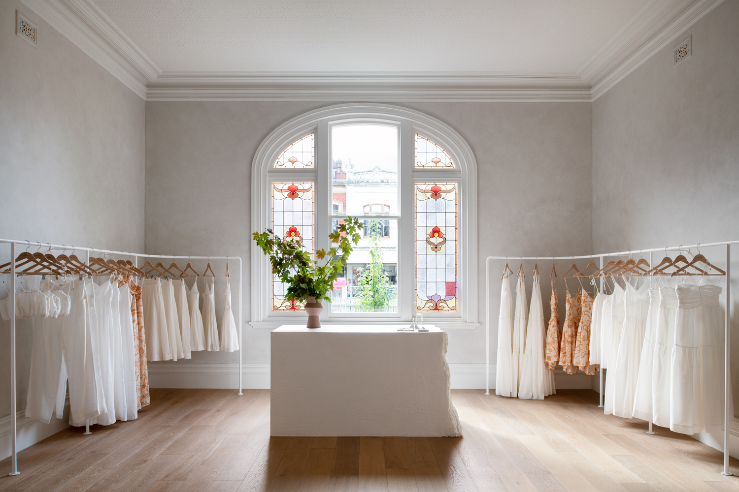 Commercial boutique interior with stained glass window designed for listed building consent in London.